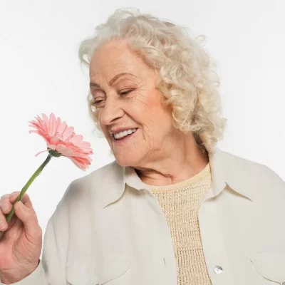 stock-photo-smiling-elderly-woman-holding-pink.webp